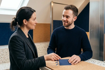 Facilitator confirming an action and ownership with a colleague before a meeting closes